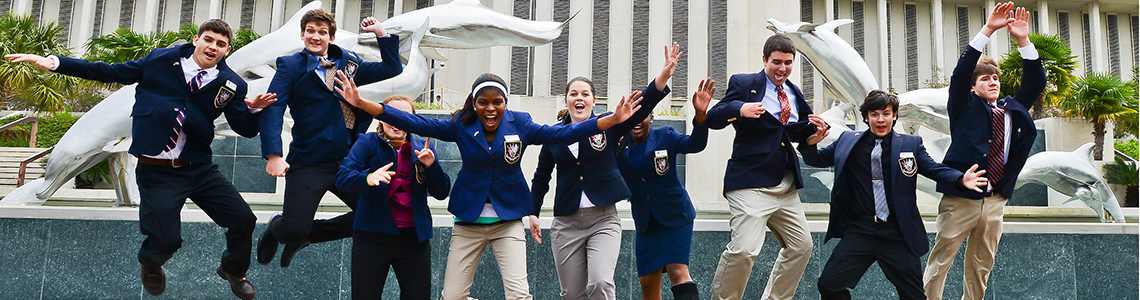 Photo of a group of Pages jumping in front of the Dolphin Fountain